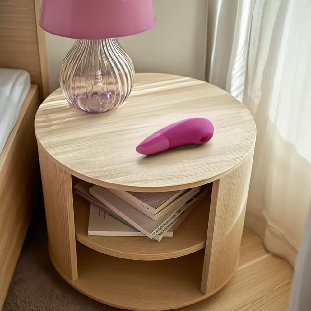 Lolita-erotic-shop-Womanizer-Enhance-pink-9 Pink Enhance on a nightstand